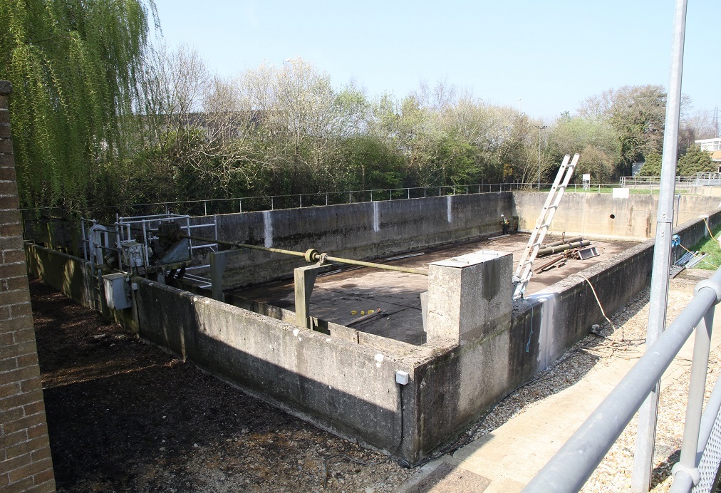 Photo of Poole Sewage storm tank prior to repair with trees in the background
